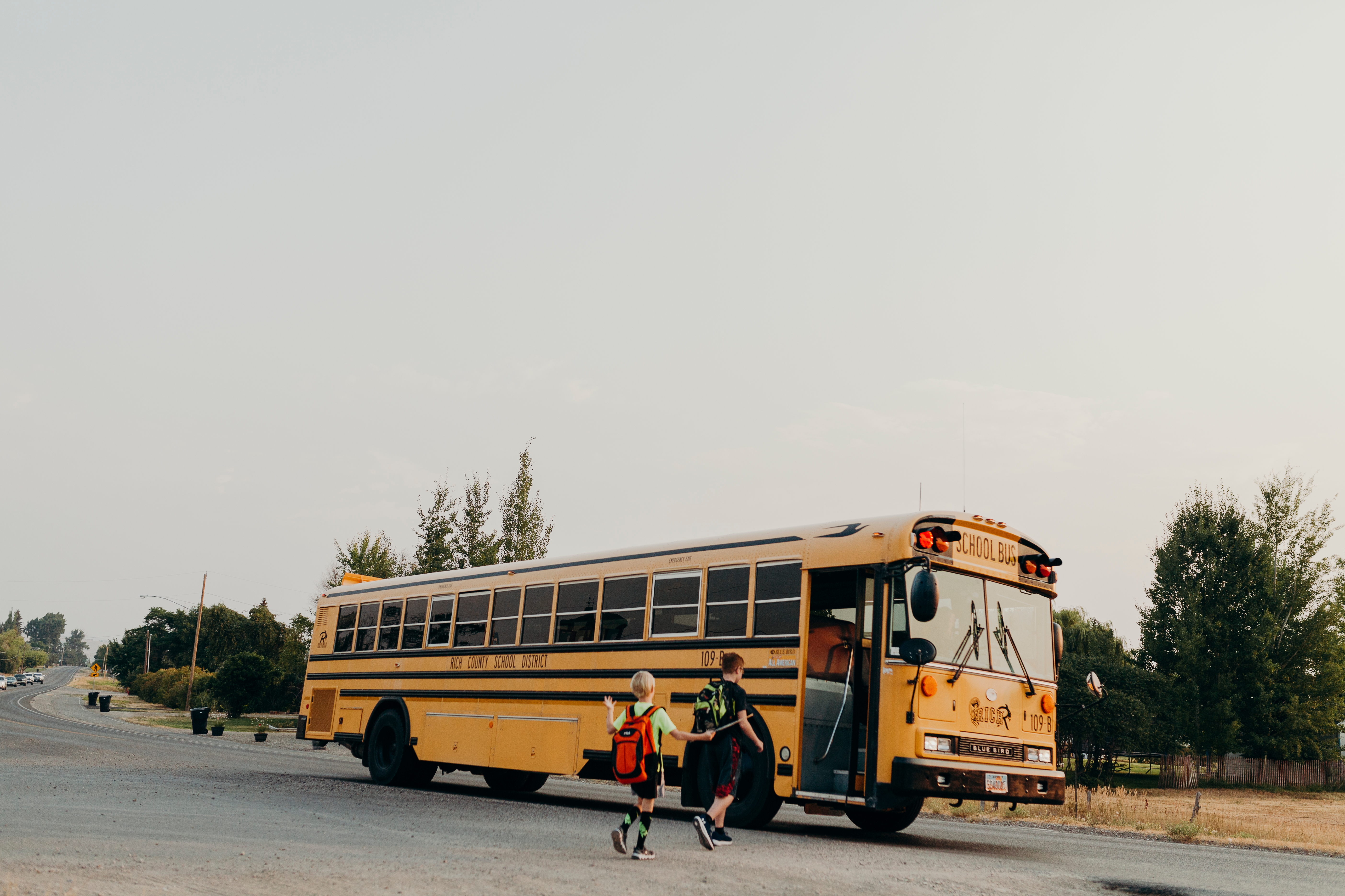 Two kids headed to their bus