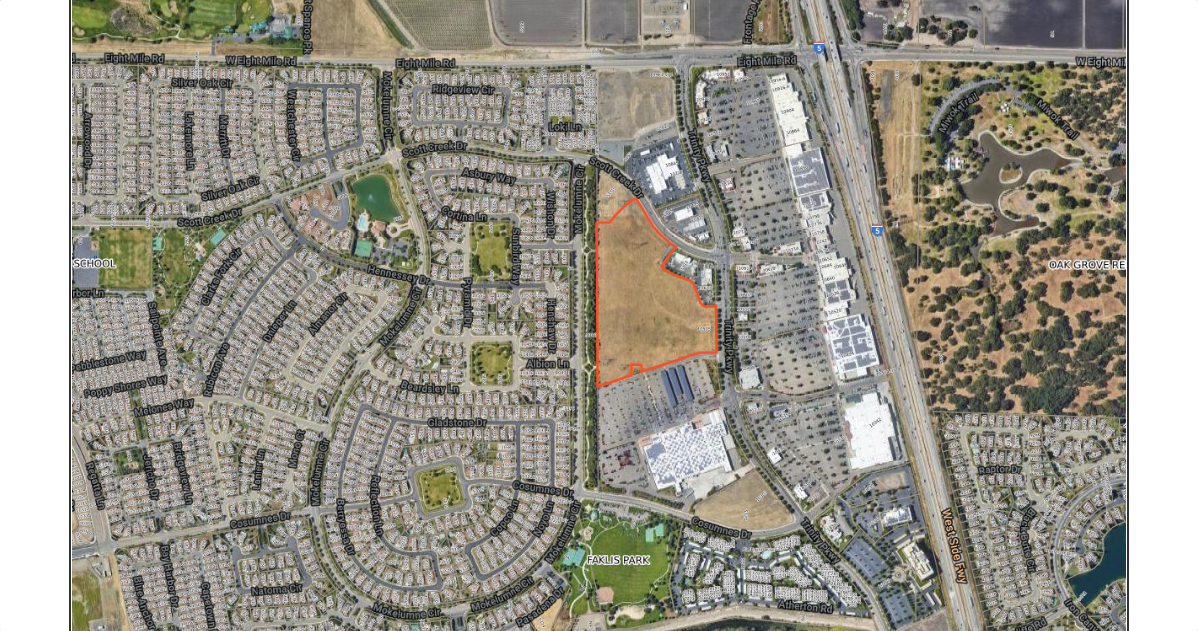 Aerial view of a proposed development site in North Stockton, outlined in red, located near the intersection of Trinity Parkway and Scott Creek Drive. The site is adjacent to residential neighborhoods and commercial properties, with plans to construct new Chick-fil-A, In-N-Out, and Dutch Bros locations, as well as a storage facility.